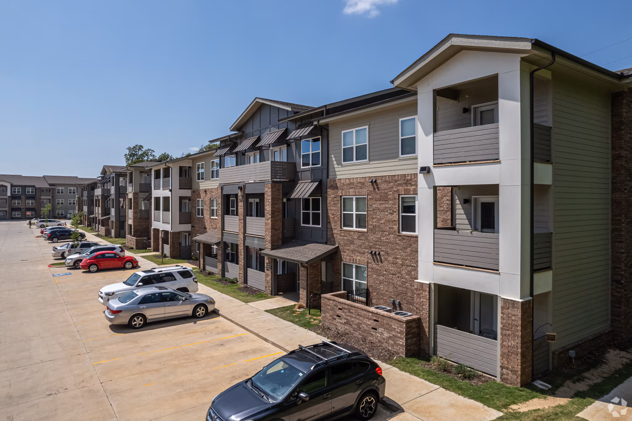 Legacy Apartment Building with brick and siding facades and private patios and decks